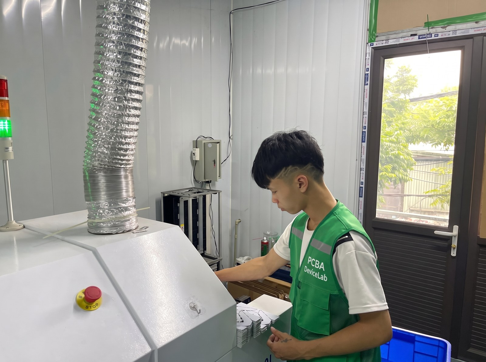 DeviceLab technician operating automated SMT pick and place machine