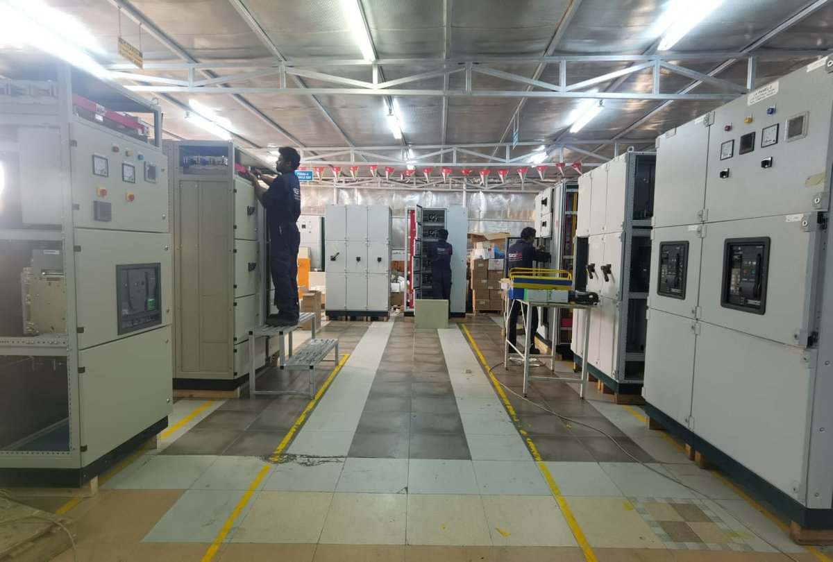 M&E engineering team inspecting IoT Gateway installation inside central chiller plant control panel